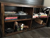 Front angled view showing the bookcase with multiple shelves filled with books and some decorative items.