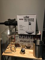 Wine decanter set with aerator in box, bottle cooler stand with dome and cleaning tool visible
