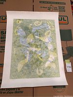 Full view of the signed and numbered print showing abstract colored shapes with a white border on textured paper.