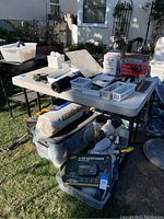 Folding table shown outdoors with various items on top in one image, but table only sold