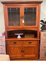 Front full view of the Mission style hutch showing the upper glass cabinet with leaded glass, open middle shelf, drawers, and two lower cabinet doors.