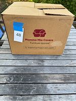Box labeled Mamma Mia Covers Furniture Apparel with website and logo showing a sofa icon.