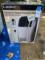 Box showing the Lasko Cyclonic Digital Ceramic Heater with Remote Control, details on features such as cyclonic heat action and digital controls.