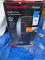 Box of Honeywell HeatGenius ceramic space heater showing branding, model name, and safety features in Spanish and English.