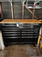 Front view of full chest showing wood top, nine drawers, casters