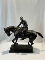 Frontal view of full sculpture showing jockey on horse and base