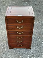 Front view of chest showing four drawers and top lid