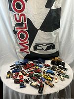 Molson Festival flag with collectible vehicles arranged on table