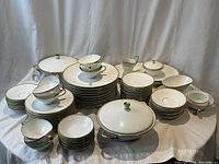 Wide view of all plates, bowls, cups and serving pieces on table