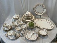 Overview of entire dinnerware and tea service arranged on table