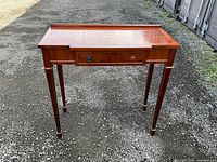 Full front view of mahogany entrance table showing drawer, legs and overall condition