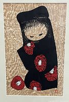 Close-up of the stylized figure in a black garment with red and white floral pattern on beige background, showing texture and detail of print.