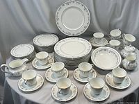 Full spread of all plates, cups, saucers and service pieces.