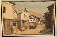 Close-up of artwork showing village street, buildings and figures