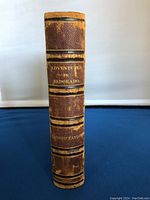 View of the spine showing the title 'Adventures in Eldorado' with gold embossed lettering on textured brown leather.