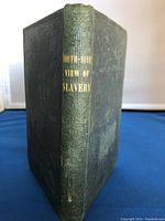 View of the book's spine showing gold embossed title 'South-Side View of Slavery' with detailed embossing on spine and worn cover.