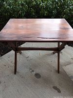 View of the entire tabletop showing square top and wood grain.