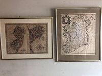 Two framed antique maps hanging on the wall, one of New Jersey/Maryland/DC and one of Ireland.