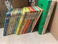 Side view of 28 Dr. Seuss books showing colorful spines with Cat in The Hat beginner books and others