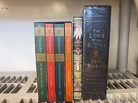 All five books: three paperbacks (Lord of the Rings vols I–III), hardcover The Hobbit, and shrink-wrapped boxed set