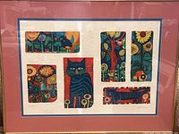 Overall view of framed artwork showing pink mat, gold frame and embossed border