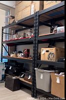 Shelf unit loaded with various household items and boxes