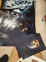 Images showing stacks of various AMC movie posters including Iron Man, Transformers, and Friday the 13th.