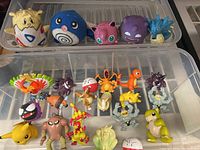 Pokémon plush toys and mini figures in plastic container