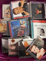 Top view of a tub filled with assorted CDs including artists Melissa Manchester, Elaine Page, Barry Manilow, Jane Morgan, and Ella Mae Morse