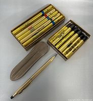 Set of Cross pens and boxes of lead refills in gold tubes, with one pen sleeve