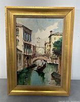 Front view of the framed vintage oil painting showing the Venice canal scene with gondolas and bridge under a partly cloudy sky.