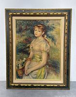 Full view of framed textured print showing the young girl with basket of flowers. Frame is vintage gold and black with ornate accents.