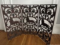 Front view of unfolded three-panel screen on hardwood floor