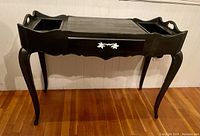 Front view of dark grey French Provincial dressing table with single drawer and curved legs.