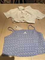 White short-sleeve collared crop shirt and blue-white Adidas logo cami top