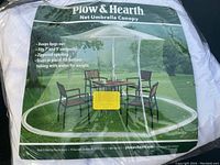 Close-up photo of the Plow & Hearth net umbrella canopy packaging showing key features and product name.