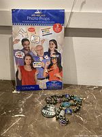 Photo of boxed 13-piece Add-Any-Age 50th birthday photo props with people holding props in celebratory poses