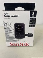 Front of SanDisk Clip Jam MP3 player box showing 8GB storage, music player image and features.