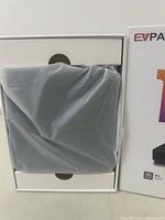 EVPAD 10P 8K streaming device wrapped in plastic inside open box showing packaging and device condition.