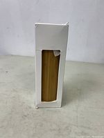White box packaging with a window showing bamboo wind chime tube inside.