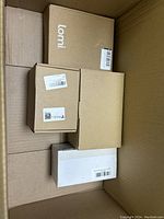 Overview of the large box showing multiple smaller boxes inside including Lomi branded box and other plain cardboard boxes.