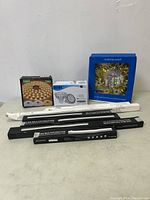 Photo showing the entire lighting lot with multiple boxed LED lights, bulbs, and LED strip lights arranged against a white wall.