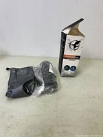 Monocular telescope in plastic wrap with black pouch and opened box showing eagle graphic and product branding.