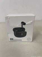 Front and slightly angled front view of the sealed box of S52 true wireless stereo earbuds showing the earbuds and charging case on the packaging.