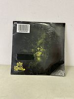 Front of sealed Wiz Khalifa vinyl record showing album art and shrink wrap with minor rip