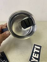 View of the cup from the top showing the clear sliding lid and handle.