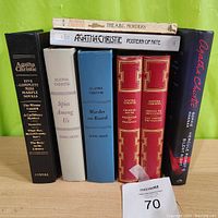 Photo of 8 books by Agatha Christie showing various editions and titles including 5 Complete Miss Marple Novels in black hardcover and other single novels in colored hardcovers, plus softcovers.