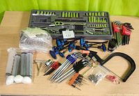 Full overview of the assortment of hand tools on display including socket trays, Allen keys, grease syringes, and flaring tool bag.