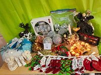 Photo showing all Christmas decorations in the lot, including cast iron reindeer tea lite holder, ornaments, wreath, angels, and advent calendar.