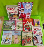 Photo of children's books, mix of hardcover and softcover, mostly Disney titles plus classics